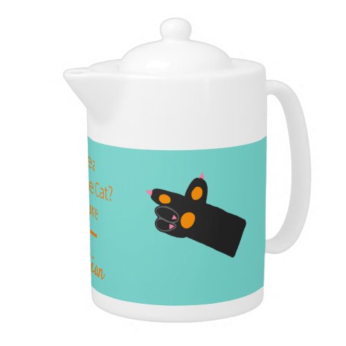 Portrait of a fluffy black cat  orange pawprints teapot