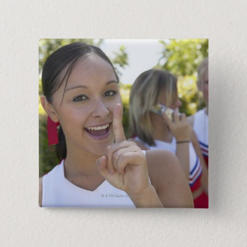 Portrait of a Teenage Cheerleader Holding a Pinback Button