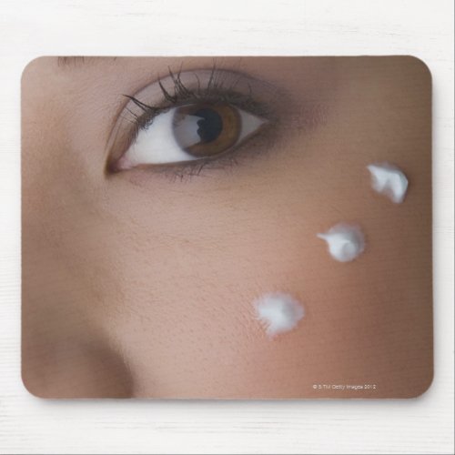 Portrait of a young woman with cream on her mouse pad