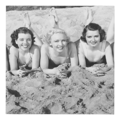 Portrait of five young women lying on the beach an faux canvas print