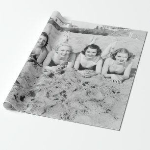 Portrait of five young women lying on the beach an wrapping paper