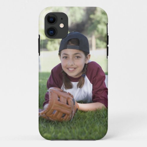 Portrait of girl lying on ground with baseball iPhone 11 case