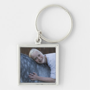 portrait of young girl on white horse keychain