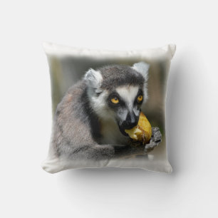 Portrait ring-tailed lemur eating a banana throw pillow