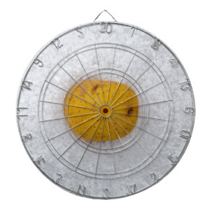 Potato macro as background with salt dartboard with darts
