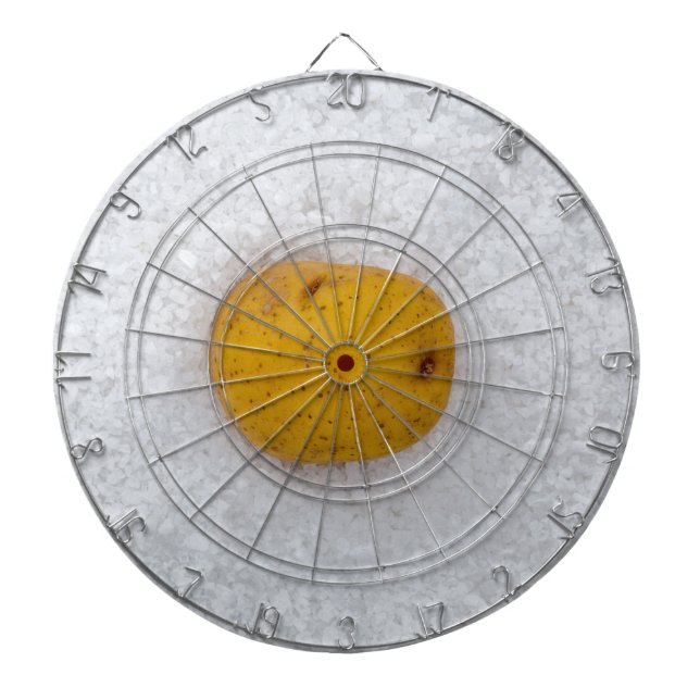 Potato macro as background with salt dartboard with darts (Front)