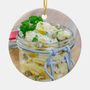 Potato salad in a jar on wooden ceramic ornament