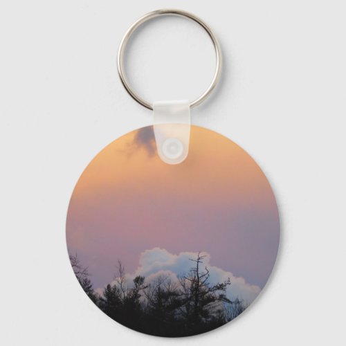 Powder blue clouds in a purple sky keychain