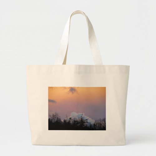 Powder blue clouds in a purple sky large tote bag