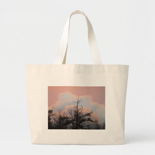 Powder blue clouds in a purple sky large tote bag