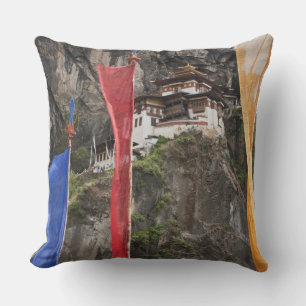 Prayer flags hang near Taktshang Throw Pillow