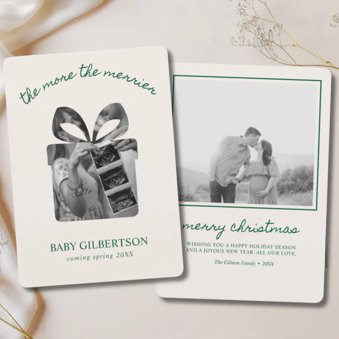 A baby announcement holiday card is shown with some baby's breath sprigs in the background.