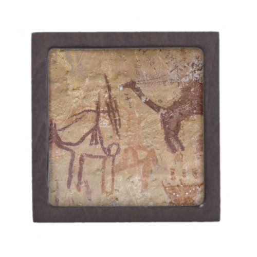 Prehistoric rock paintings with camels and gift box