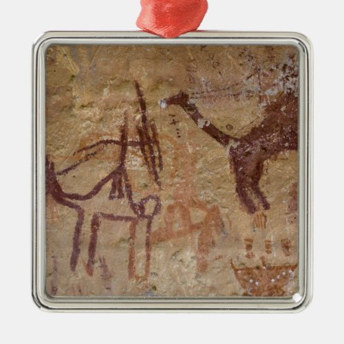 Prehistoric rock paintings with camels and metal ornament