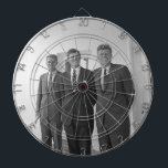 President John Kennedy & Brothers American Camelot Dart Board<br><div class="desc">The sun beat down on the three Kennedy brothers as they stood beneath the familiar white portico of the White House. President John F. Kennedy, the eldest, leaned against a pillar, a wry smile playing on his lips. His younger brothers, Robert and Ted, stood beside him, their faces a mix...</div>