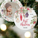 Pretty floral watercolor baby first Christmas  Ceramic Ornament<br><div class="desc">Celebrate your baby's first Christmas with our adorable hand-painted tree ornament. Featuring charming illustrations of rustic green pine branches, festive red berries, delicate beige flowers, and Christmas ornaments baubles in all shapes and colors. Commemorate this special milestone with a unique and festive ornament that adds a touch of holiday magic...</div>