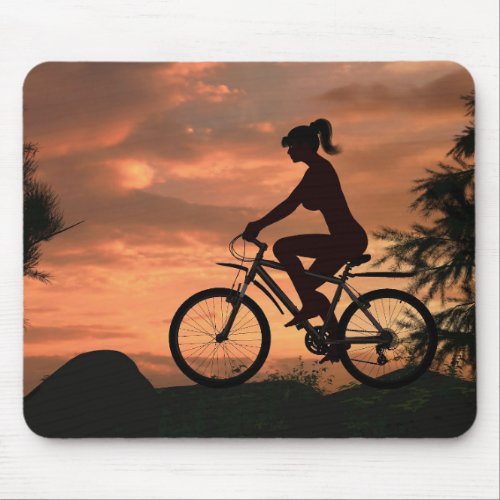 Pretty girl riding her bike at sunset mouse pad