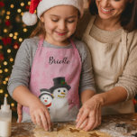 Pretty Pink Christmas Snowman Personalized Kids   Apron<br><div class="desc">This small size Christmas apron was created for kids/girls to wear to bake holiday cookies,  paint or play in throughout the winter season. The design features a pretty pink background with snowflakes,  snow,  and snowmen. Personalize this cute apron with your child's name.</div>