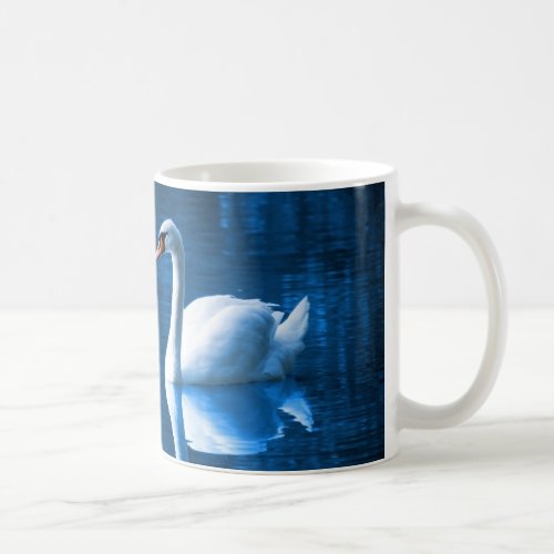 Pretty white swan floating on a blue lake coffee mug