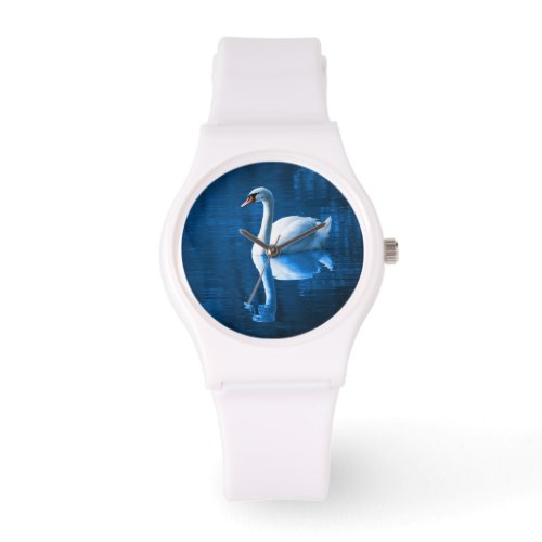 Pretty white swan floating on a blue lake watch