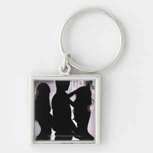 Profile of a man dancing with women in a nightclub keychain
