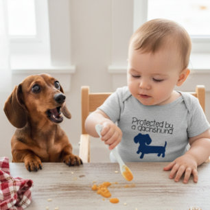 Protected by a Dachshund (blue) Baby Bodysuit