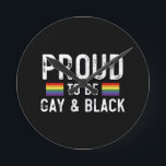 Proud To Be Gay And Black Round Clock<br><div class="desc">Proud To Be Gay And Black 
gay, lgbt, black, gay, pride, gift, funny, lqbtq, love, bisexual, transgender, queer, protest, black, rainbow, blue, flag, bi, trans, gay daughter, gifts</div>