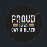 Proud To Be Gay And Black Round Clock<br><div class="desc">Proud To Be Gay And Black 
gay, lgbt, black, gay, pride, gift, funny, lqbtq, love, bisexual, transgender, queer, protest, black, rainbow, blue, flag, bi, trans, gay daughter, gifts</div>