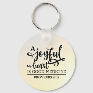 Proverbs 17:22 A cheerful heart is good medicine Keychain