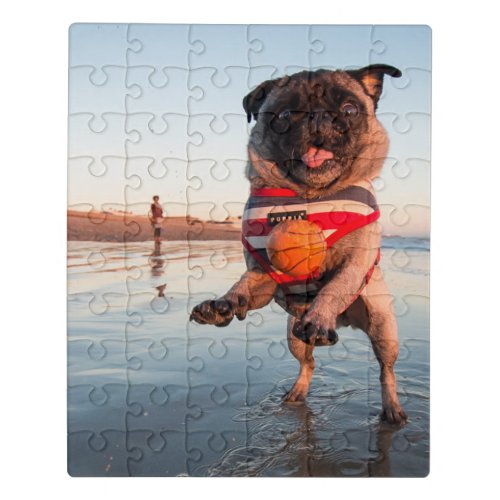 Pug Playing Ball on Beach Jigsaw Puzzle