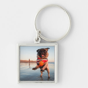 Pug Playing Ball on Beach Keychain