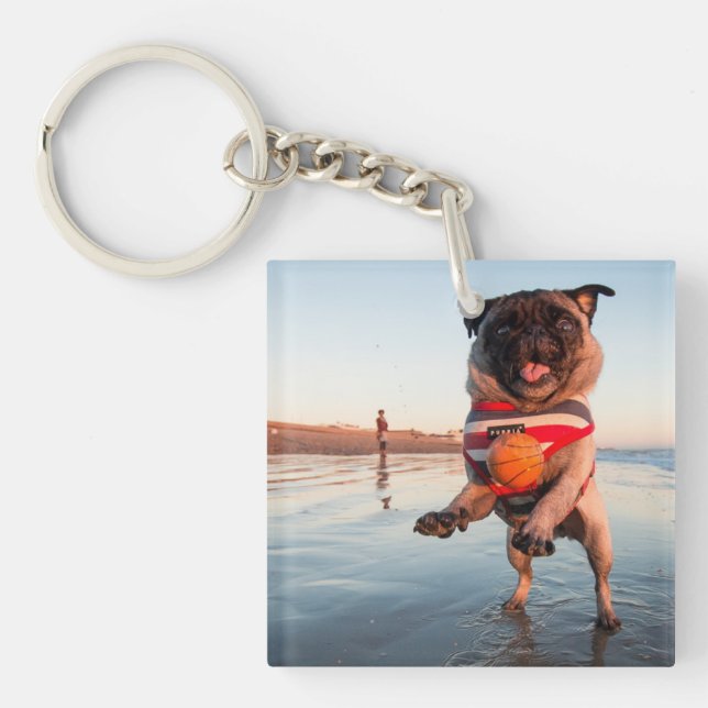 Pug Playing Ball on Beach Keychain (Front)