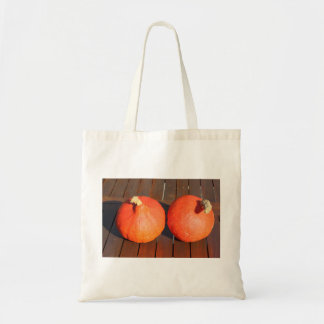 Pumpkins on a wooden table tote bag
