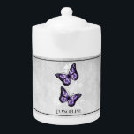 Purple Butterfly Floral Teapot<br><div class="desc">Enjoy your tea with a Purple Butterfly Floral Personalized Teapot.  Teapot design features a pair of vibrant butterflies resting on a white floral vine against a light gray grunge background. Additional gift items available with this design as well as a variety of colors.</div>