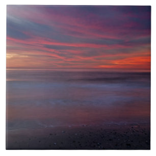 Purple-colored sunrise on ocean shore ceramic tile