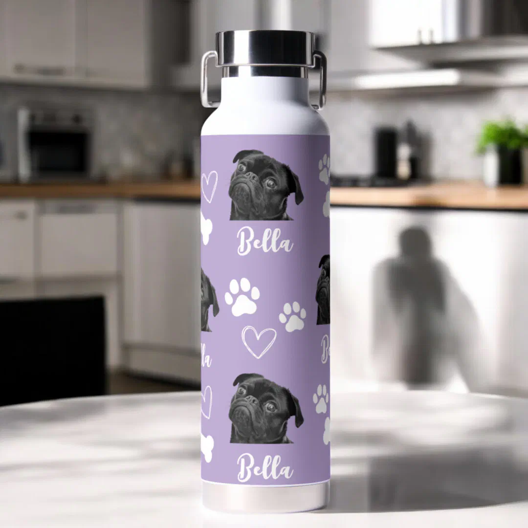 Purple custom pet photo water bottle with love paw print design for dog lovers sitting on a kitchen counter.