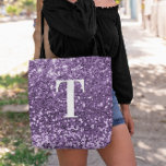 Purple Faux Glitter Bokeh Sparkles Monogrammed Tote Bag<br><div class="desc">A modern bold single letter monogram in white with a black drop shadow. The font size, color and style are customizable. The background is a faux purple glitter with sparkly spots or bokeh. Move or delete the tiny faux sparkle graphics. A nice gift for a bridesmaid or other member of...</div>