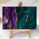 Purple Gold Agate Teal Wedding Table Number<br><div class="desc">The left-hand edge of this elegant modern wedding table number card features a purple watercolor agate border trimmed with faux gold glitter. The customizable text combines gold-colored handwriting,  and italic and copperplate fonts on a teal blue watercolor agate background.</div>