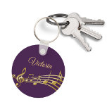 Purple gold music notes monogram name keychain<br><div class="desc">Simple and elegant for a music lover! Feminine purple background with faux gold music notes. Template for your name,  golden hand lettered style script.</div>