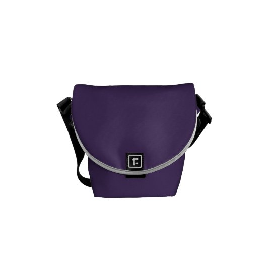 Purple messenger bag with floral print interior