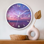 Purple ocean sunset clouds photo modern elegant clock<br><div class="desc">Get inspired whenever you check the time on this photography wall clock of a gorgeous, softly lit purple, pink, and blue sunset over the Pacific Ocean. Your choice of a round or square clock face. Makes a great housewarming gift! You can easily personalize this wall clock. Please message me with...</div>