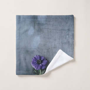 Purple petaled flower on gray surface wash cloth