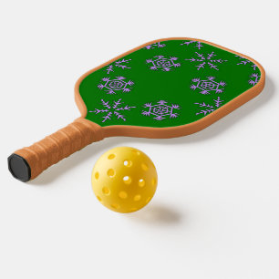 Purple snowflakes on green pickleball paddle