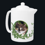 Purrrfect Tea Cute Calico Kitten Teapot<br><div class="desc">Cat lovers will delight in this teapot with cute calico kitten snuggled in a jade plant. Her unique green eyes are irresistible. Purrrfect Tea for You and Me text is included. Text may be personalized in template provided. You may also enjoy matching mugs and tea jar as well as the...</div>