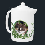 Purrrfect Tea Cute Calico Kitten Teapot<br><div class="desc">Cat lovers will delight in this teapot with cute calico kitten snuggled in a jade plant. Her unique green eyes are irresistible. Purrrfect Tea for You and Me text is included. Text may be personalized in template provided. You may also enjoy matching mugs and tea jar as well as the...</div>