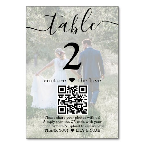 QR Code 2 Photo Any Text Capture the Love Wedding Table Number - Add a personalized finishing touch to wedding reception decorations with custom photo & QR Code table number cards. Pictures and all text are simple to customize, and can be different or the same on front and back. If preferred, change "capture the love" to "honeymoon fund," "a special thanks," "menu," "our love story" or other text of your choice. (IMAGE PLACEMENT TIP: An easy way to center a photo exactly how you want is to crop it before uploading to the Zazzle website.) By scanning the QR code with their phone camera, guests are sent directly to a wedding website or other online location with any important / entertaining information, such as a video message, digital payment app, or social media page. The two-sided black and white design features modern minimalist typography, handwritten script calligraphy, 2 custom QR codes, and your pictures. These elegant and unique table number cards make a stylish addition to a special day celebration. Example photo on front is by Tim Stagge on Unsplash.