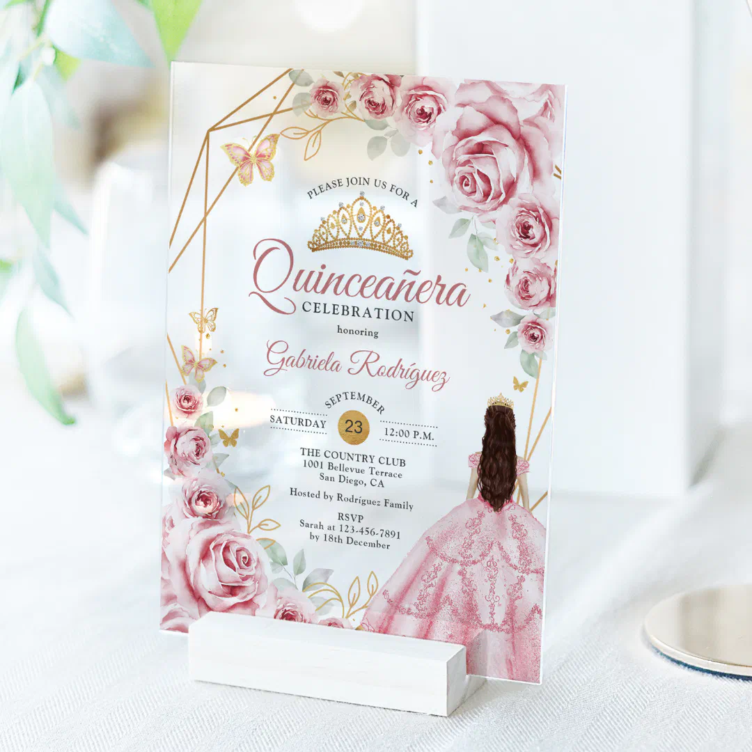 A clear background with the acrylic invitation as main focus. There are geometric lines, pink roses, a gold tiara, and a girl with long brown hair facing backwards in a pink princess dress.