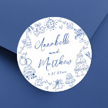 Quirky Hand Drawn Blue Whimsical Wedding Classic Round Sticker<br><div class="desc">Personalized Hand-Drawn Quirky Blue Wedding Stickers. These fun and playful round wedding stickers feature quirky doodle illustrations surrounding the edges, all in a vibrant blue theme. Elements like a champagne tower, wedding cake, disco ball, hearts, wedding bells, rings, cameras, and more create a whimsical and celebratory vibe. The bride and...</div>