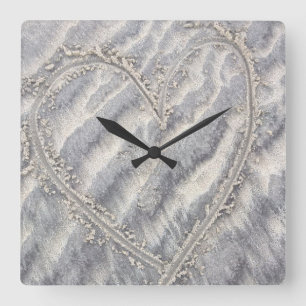 Quirky heart drawing in the sand square wall clock