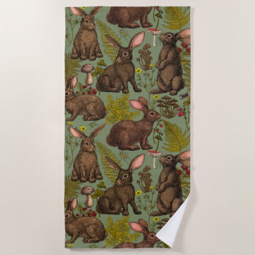 Rabbits and woodland flora Beach Towel